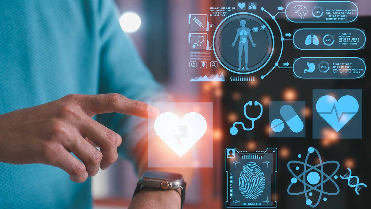 Fotografia de uma mão apontando para um monitor com dados médicos. 